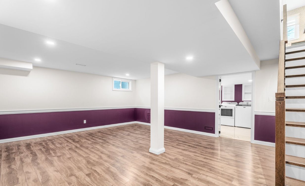 Finished basement rec room with laminate flooring and pot lights