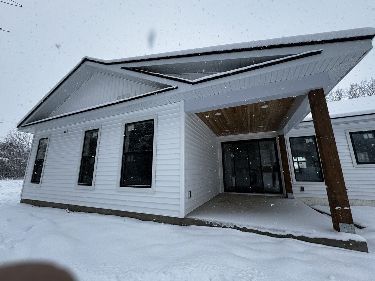 Covered entry porch with a timber post on a new custom home