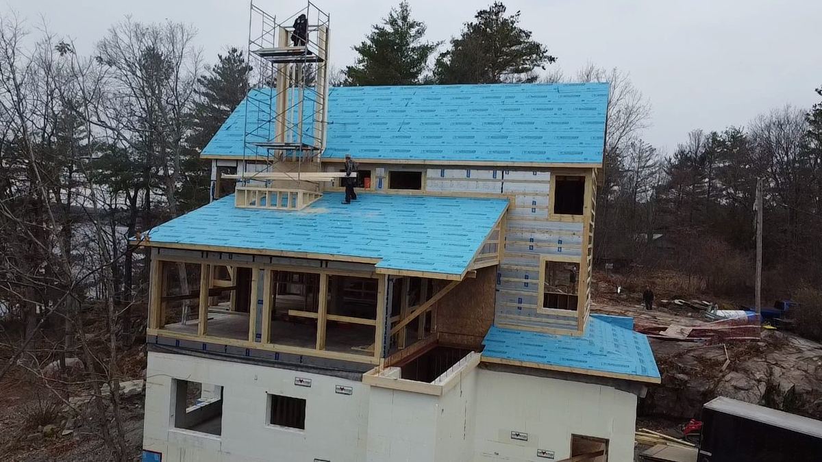 Custom home being framed on a rocky rural lot