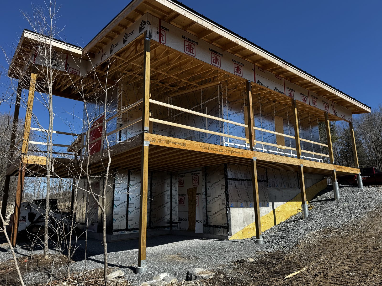 Two-storey wraparound deck framed on a new custom home