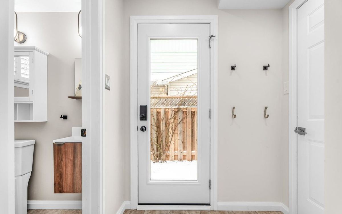 Renovated entryway and mudroom with built-in storage and a glass back door
