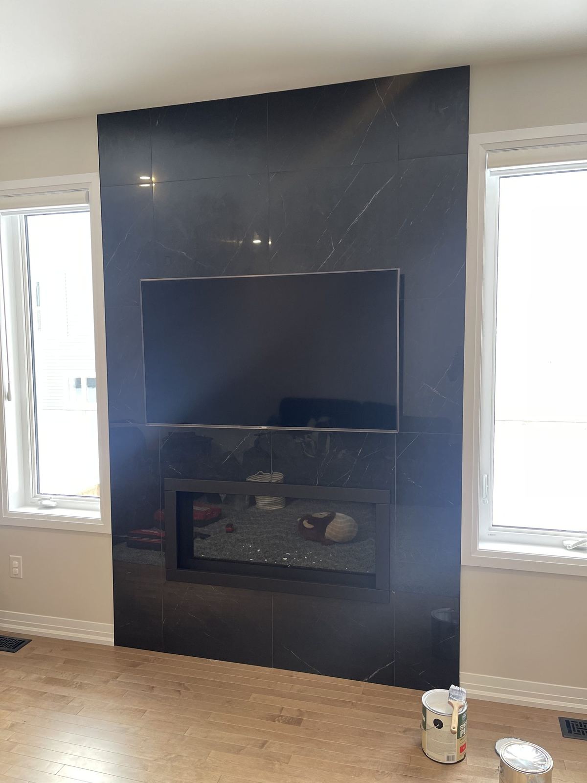 Floor-to-ceiling fireplace feature wall with a linear fireplace