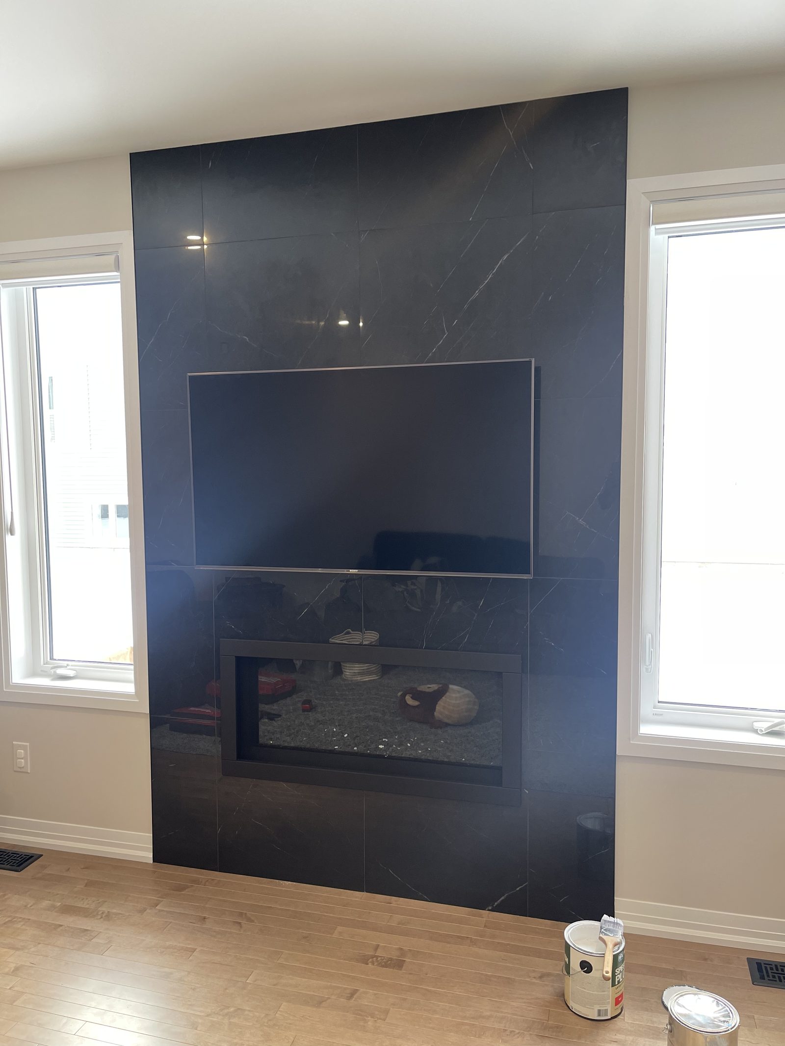 Floor-to-ceiling fireplace feature wall with a linear fireplace