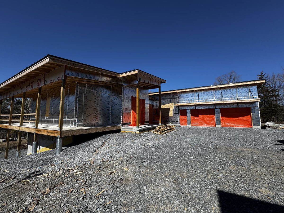 Attached garage and main house of a modern custom home under construction