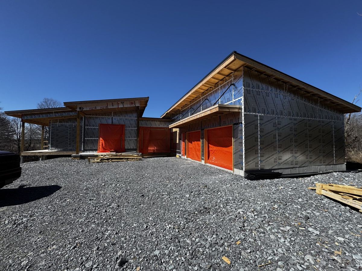 Garage wing of a modern custom home with timber-framed overhangs
