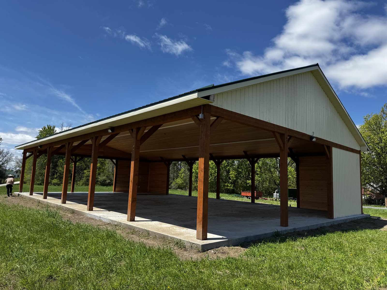 Open timber pavilion with exposed posts and beams on a concrete slab